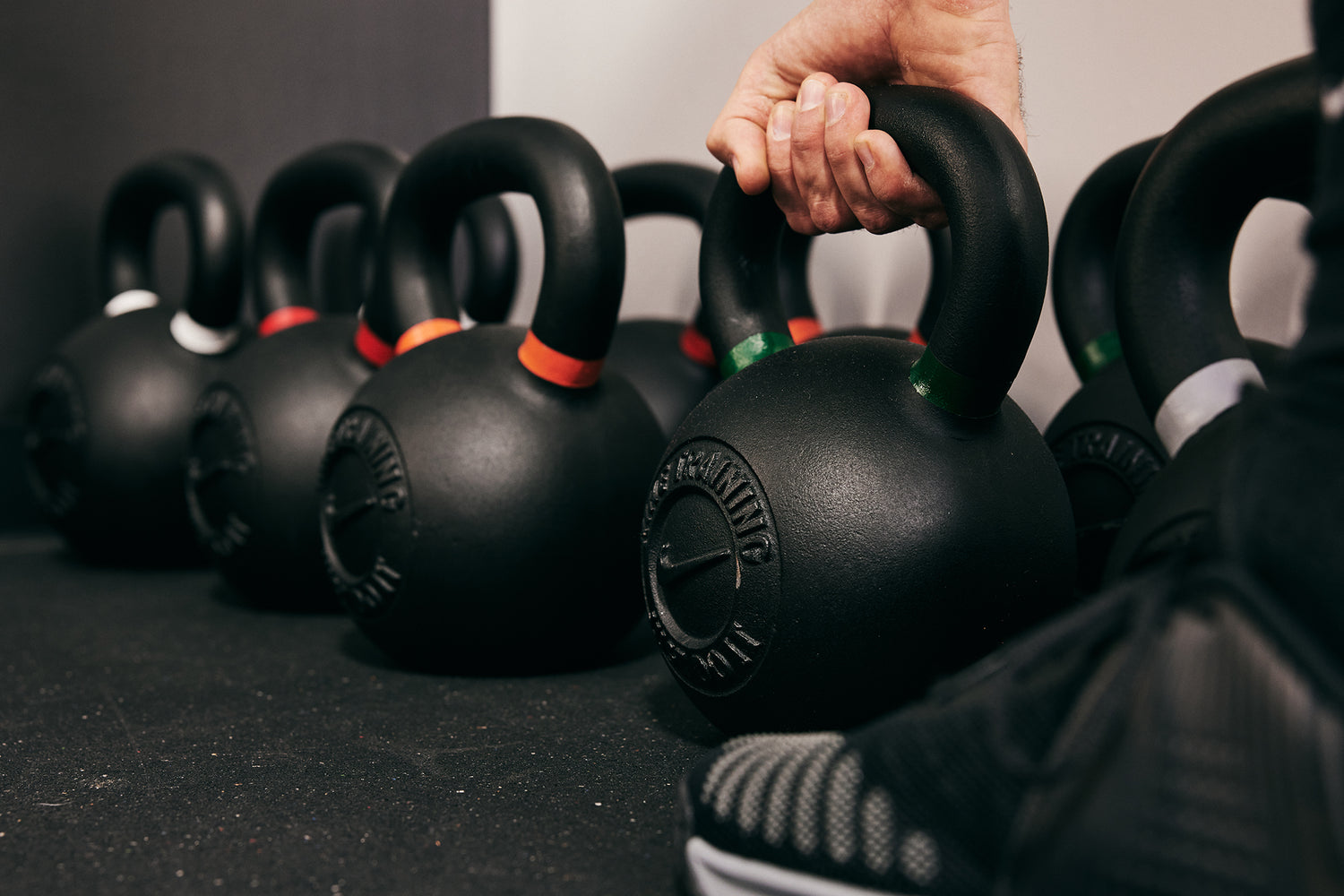 A variety of the Nike Kettlebell sitting on the gym floor