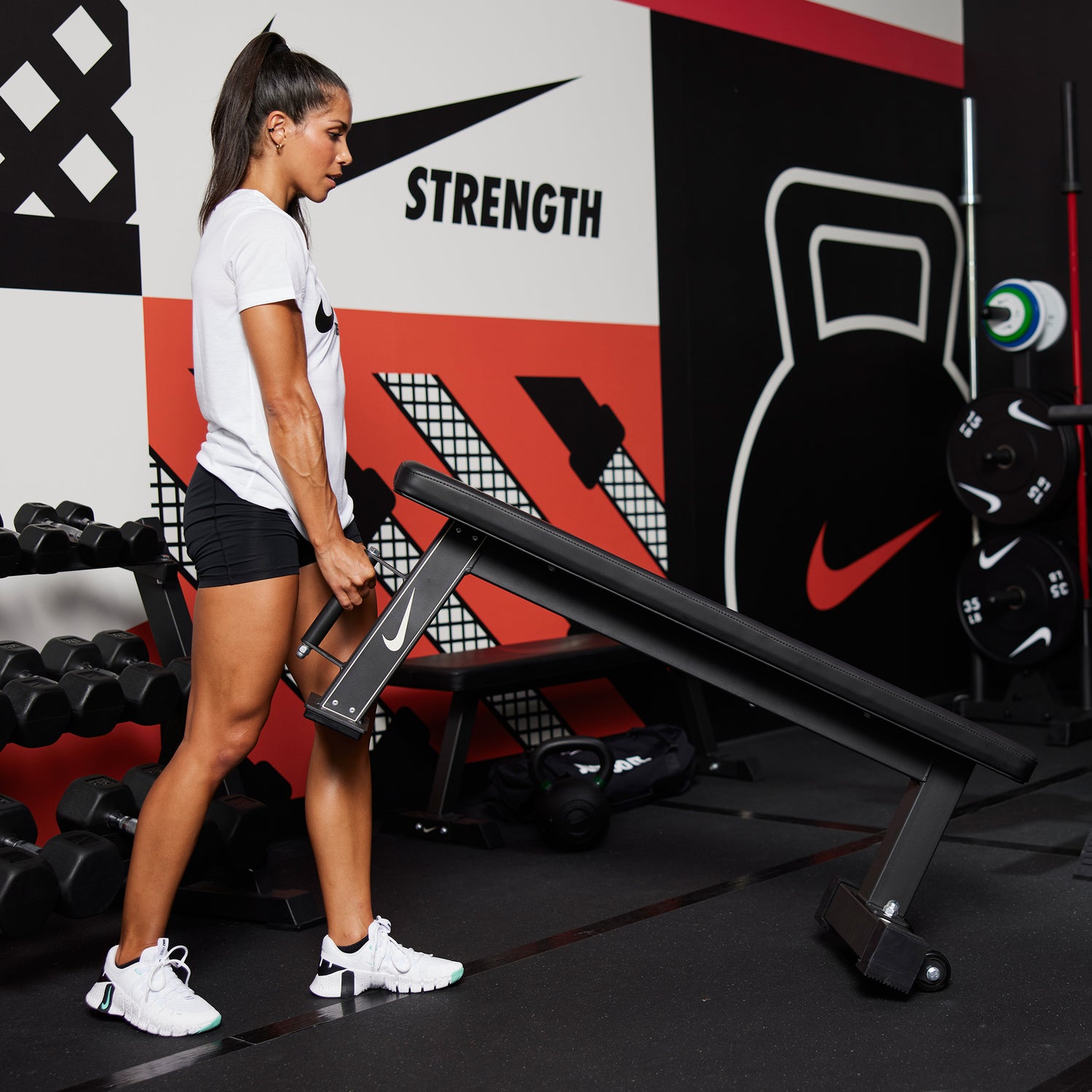 Athlete using the handle to roll the Nike Rolling Weight Bench