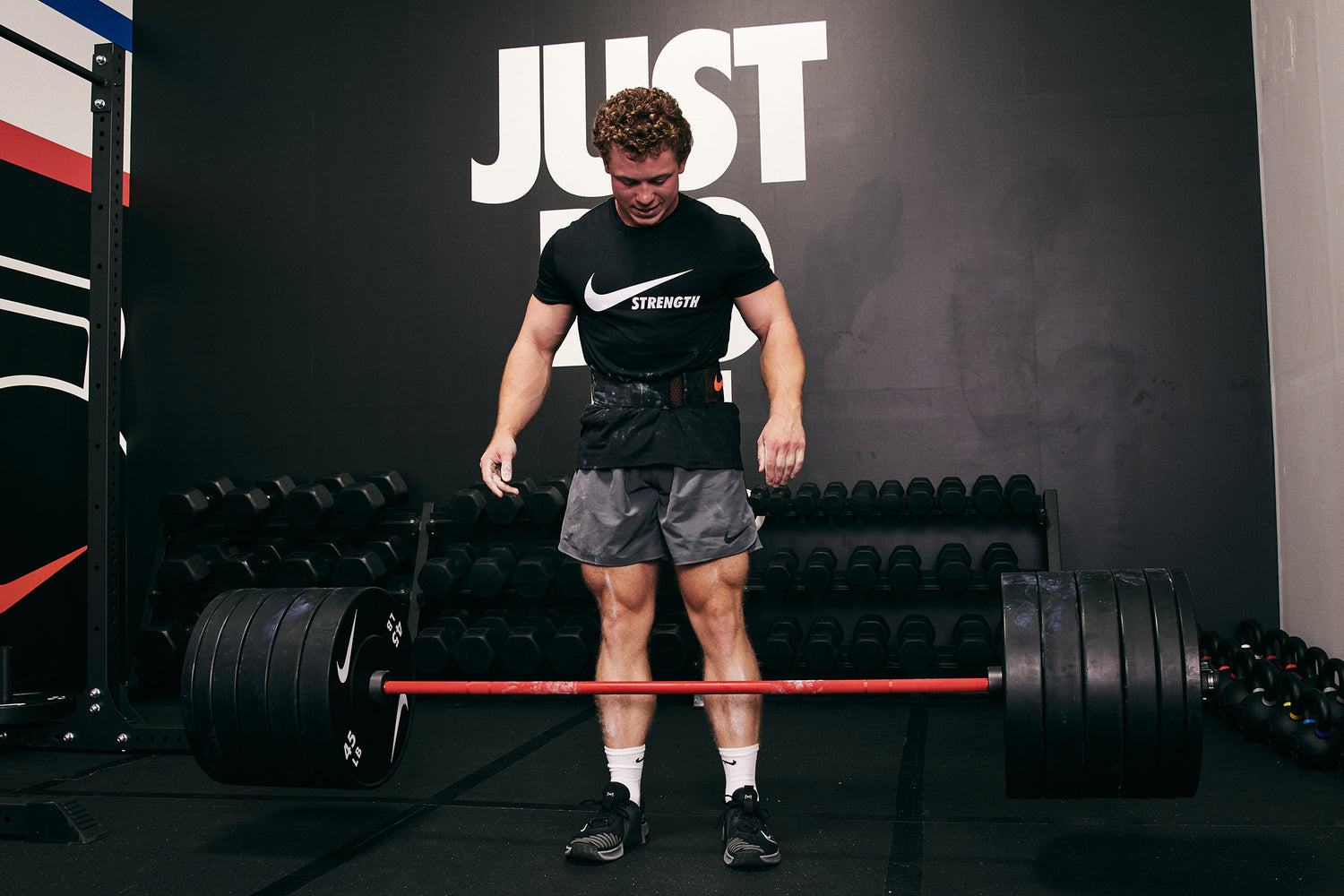 Strong male athlete dropping the Nike Coated Premium Barbell 20kg with 400+ LB of Nike Rubber Bumper Plates