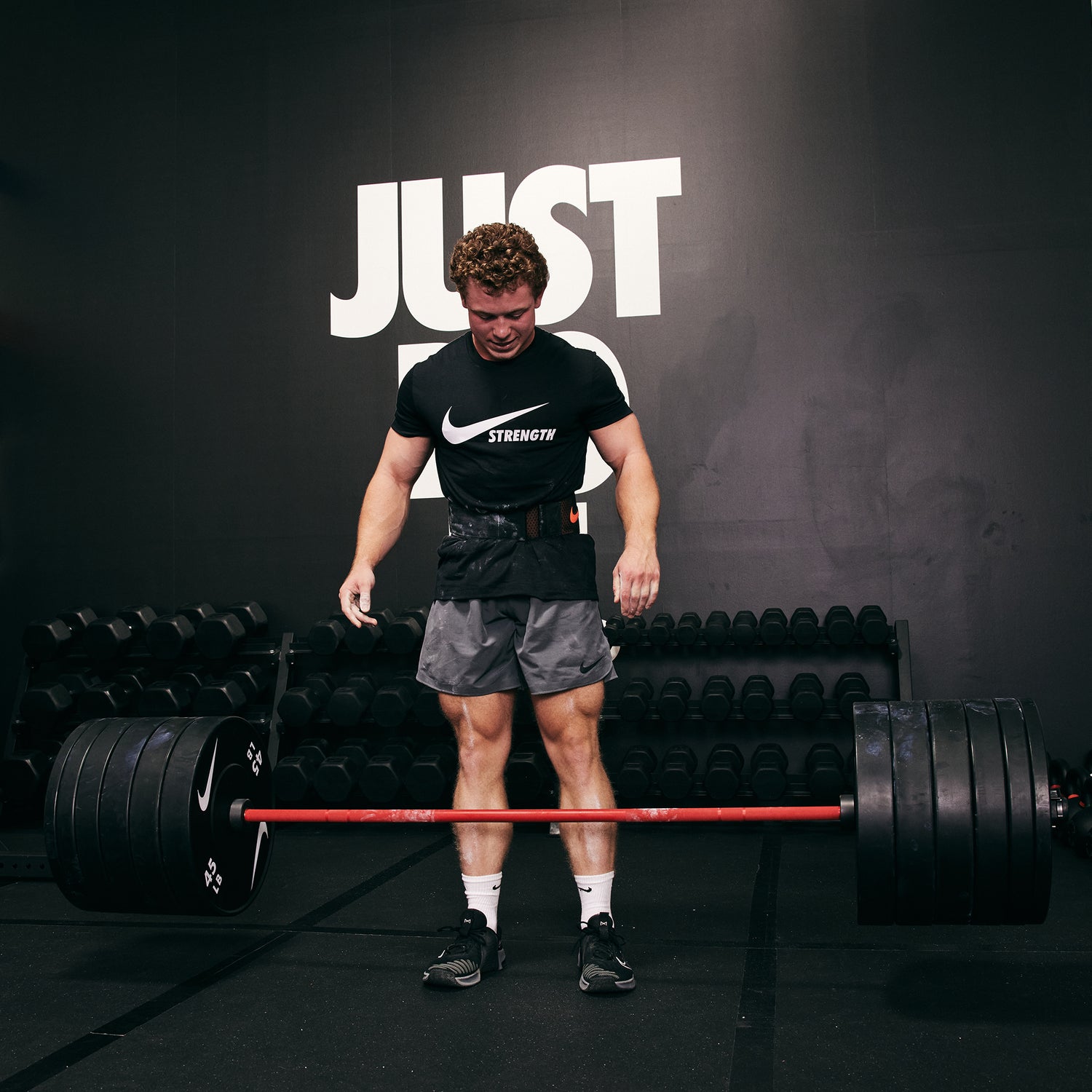 Strong male athlete dropping the Nike Coated Premium Barbell 20kg with 400+ LB of Nike Rubber Bumper Plates