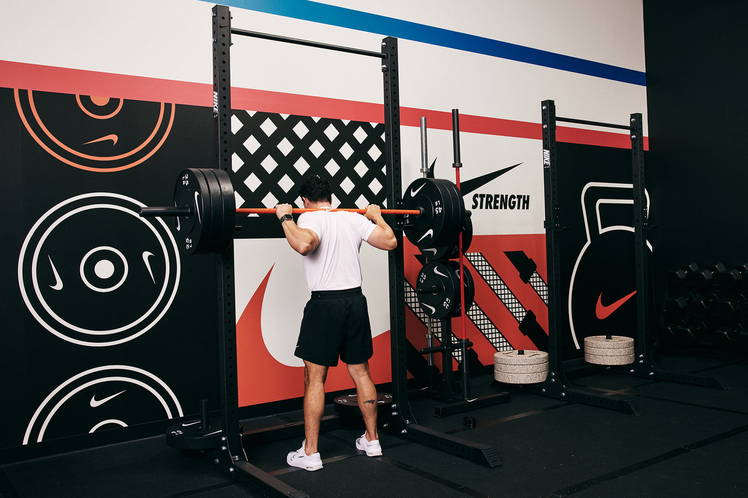 Male athlete preparing to squat at the Nike Squat Rack