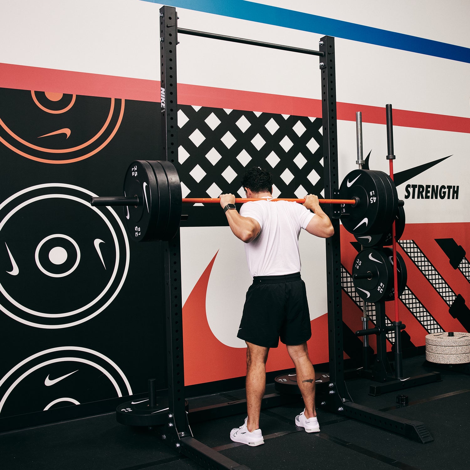 Male athlete preparing to squat at the Nike Squat Rack