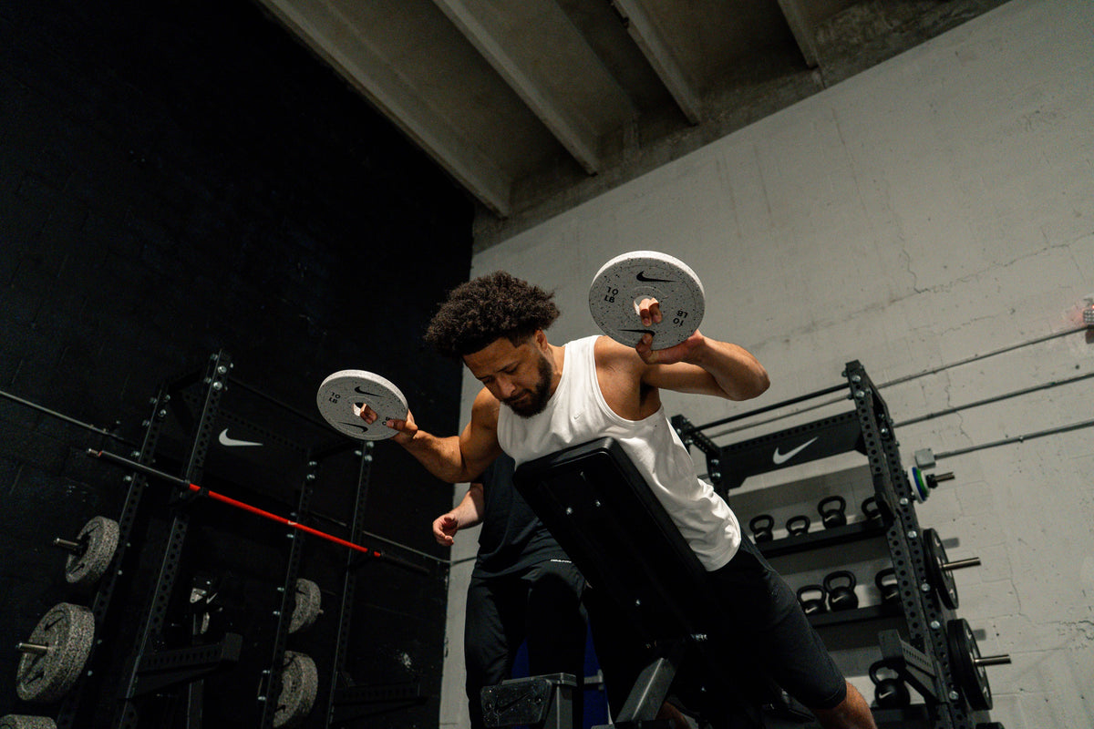 Cade Cunningham training with change plates, a bench and a kettlebell