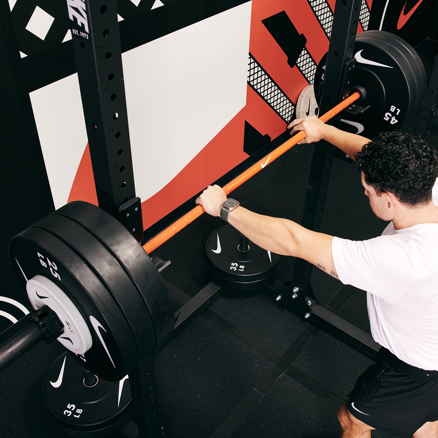 Male athlete preparing for a heavy lift at the Nike Squat Rack