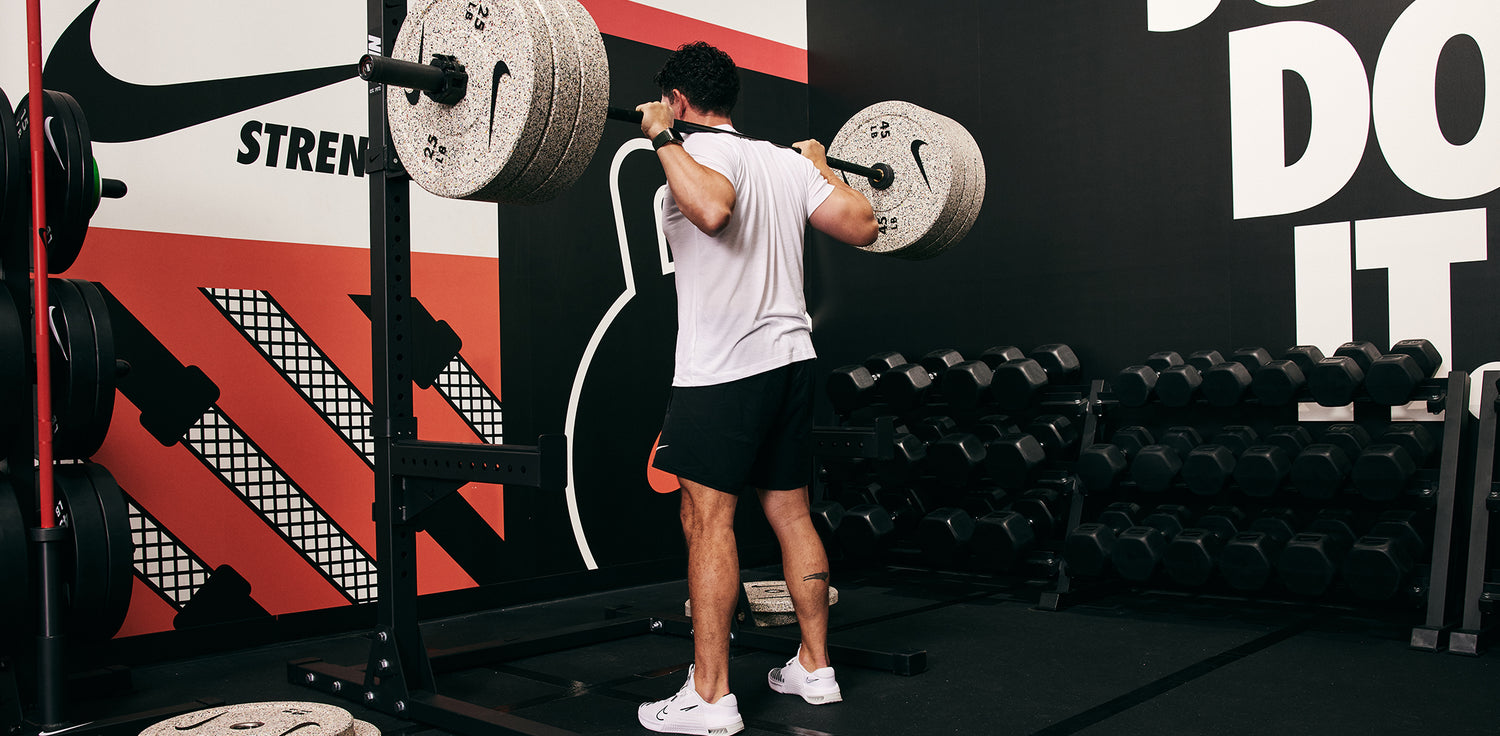 Male athlete squatting heavy with the Nike Squat Stand