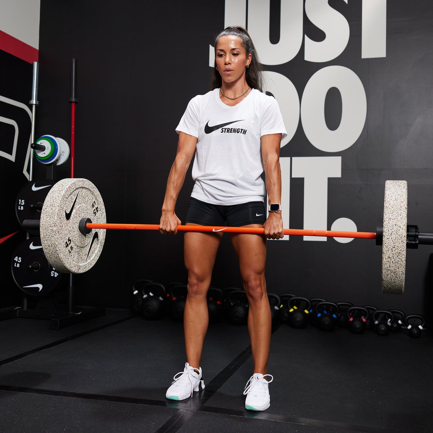 Female athlete deadlifting the Nike coated premium barbell 15kg with Nike Rubber Bumper Plate (Grind) Plates