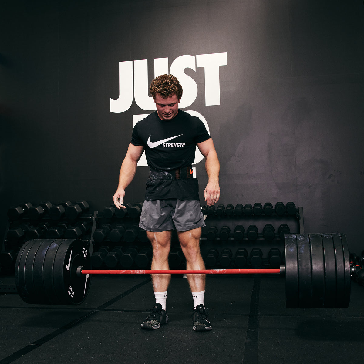 Strong male athlete dropping the Nike Coated Premium Barbell 20kg with 400+ LB of Nike Rubber Bumper Plates
