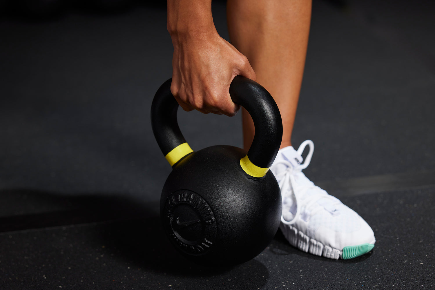 Athlete grabbing the handle for the Nike Kettlebell 35 LB
