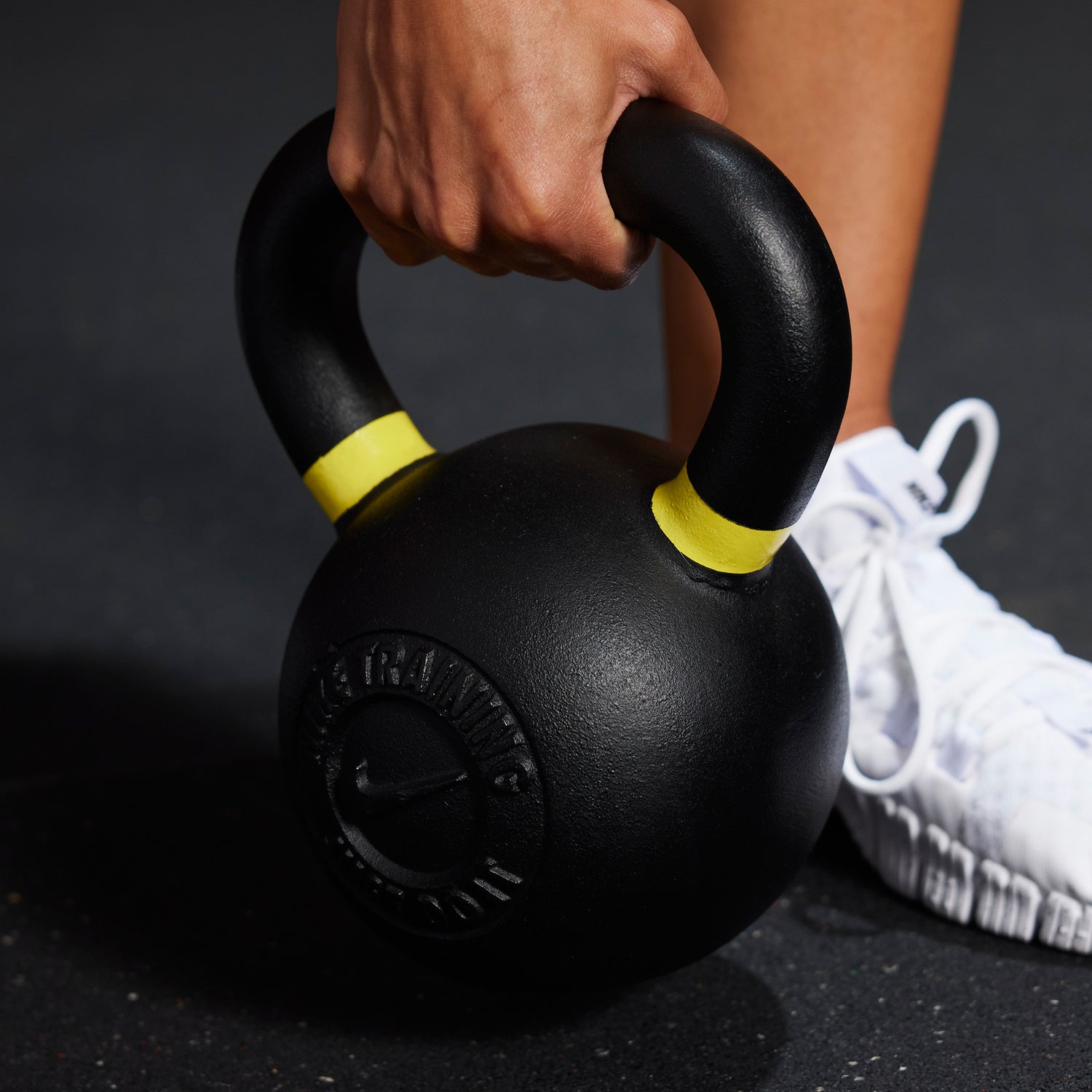 Athlete grabbing the handle for the Nike Kettlebell 35 LB