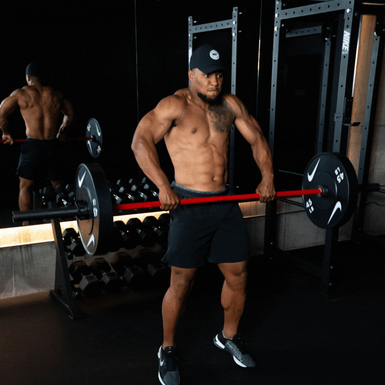 GIF of nike athlete Saquon Barkley hang cleaning as the Nike Coated Premium Barbell 20kg rotates in his hands